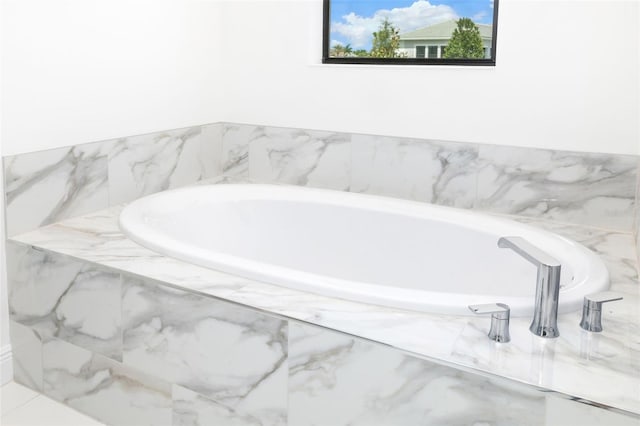 bathroom with tiled bath