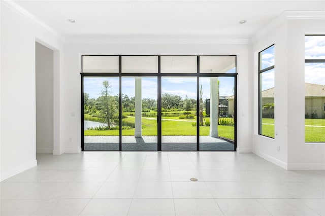 entryway featuring light tile patterned flooring, ornamental molding, and a wealth of natural light