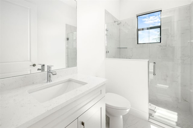 bathroom featuring vanity, toilet, and a shower with door