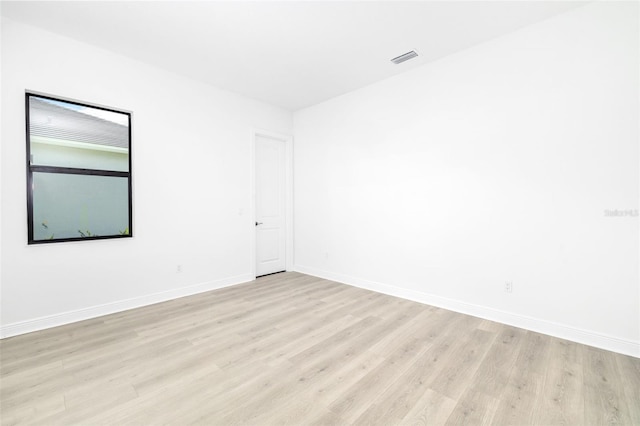 spare room with light hardwood / wood-style floors