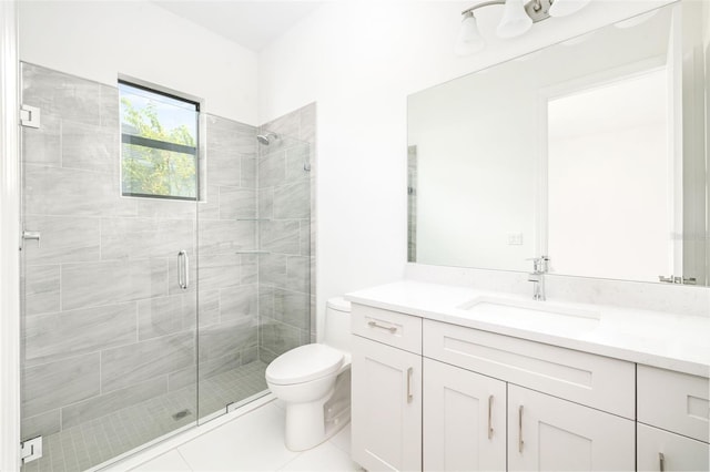 bathroom with vanity, tile patterned flooring, toilet, and a shower with door