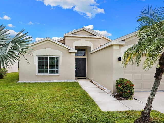 view of front of home featuring a garage and a front yard