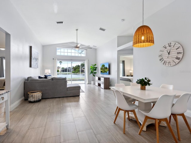 dining room with ceiling fan, lofted ceiling, and light hardwood / wood-style floors