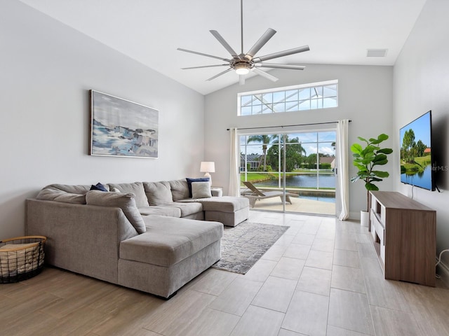 living room featuring ceiling fan, light wood-type flooring, and high vaulted ceiling