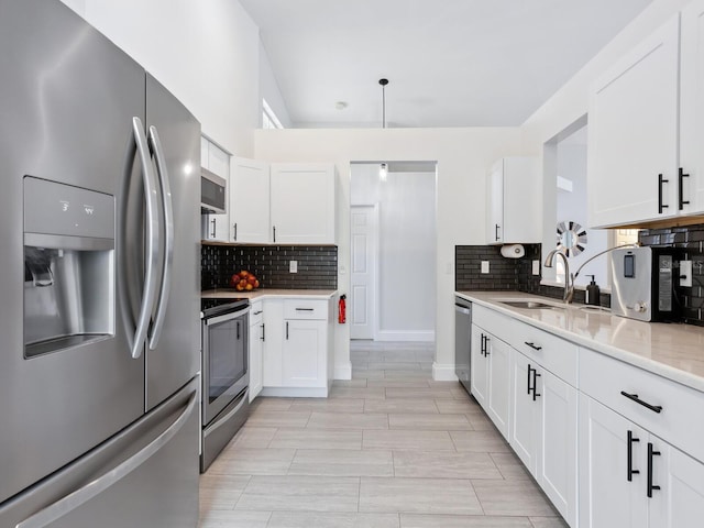 kitchen featuring sink, stainless steel appliances, and white cabinets