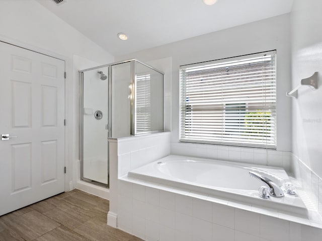 bathroom featuring independent shower and bath