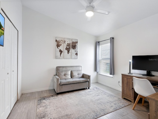 home office featuring light wood-type flooring, vaulted ceiling, and ceiling fan