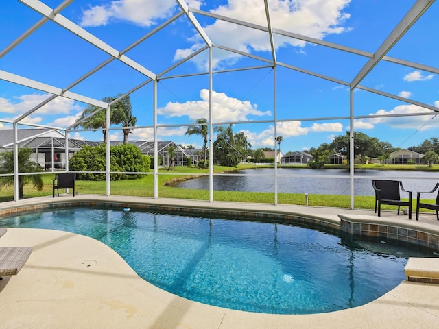 view of swimming pool featuring glass enclosure, a water view, a yard, and a patio area