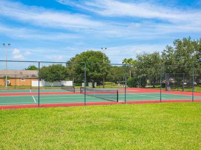 view of sport court featuring a lawn