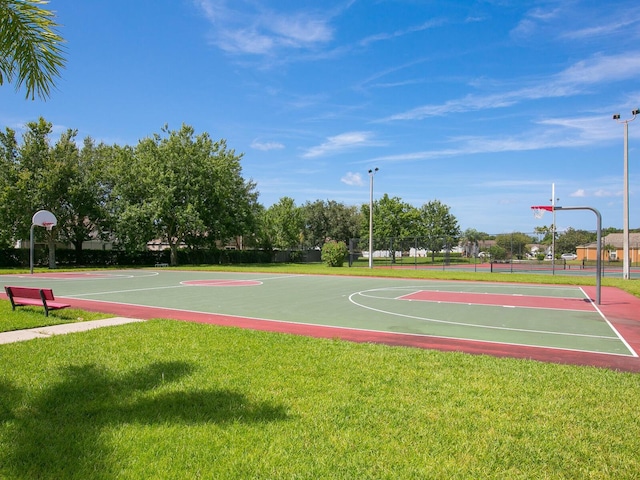 view of sport court featuring a yard