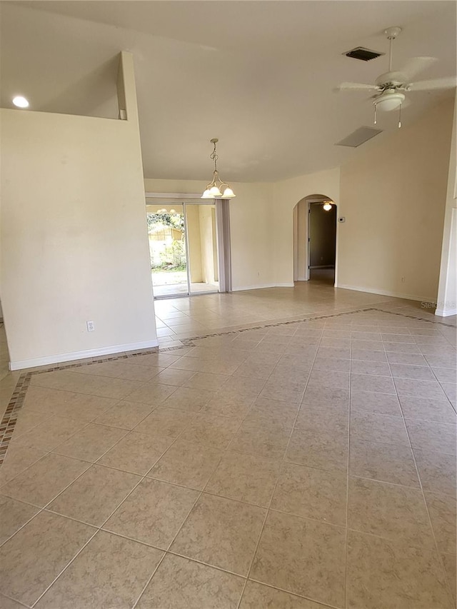 tiled spare room with ceiling fan