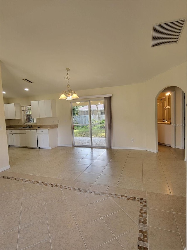 interior space with light tile patterned flooring and a chandelier