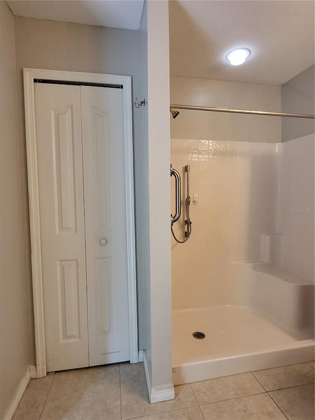 bathroom featuring tile patterned flooring and a shower