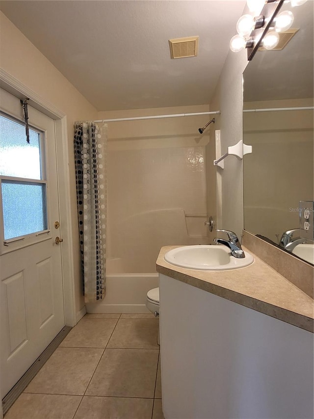 full bathroom featuring tile patterned floors, vanity, toilet, and shower / tub combo