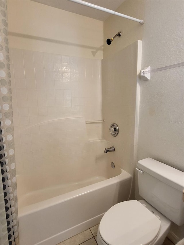 bathroom featuring tile patterned floors, shower / bathtub combination with curtain, and toilet