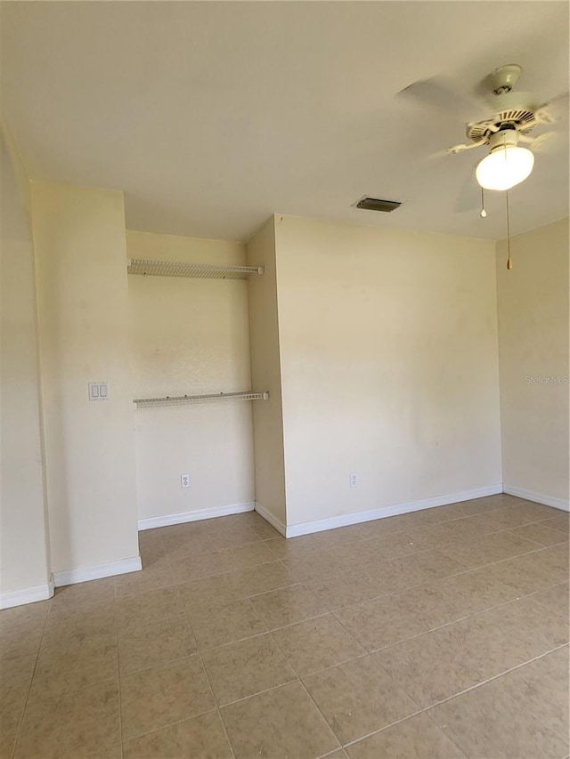 unfurnished room featuring light tile patterned floors and ceiling fan