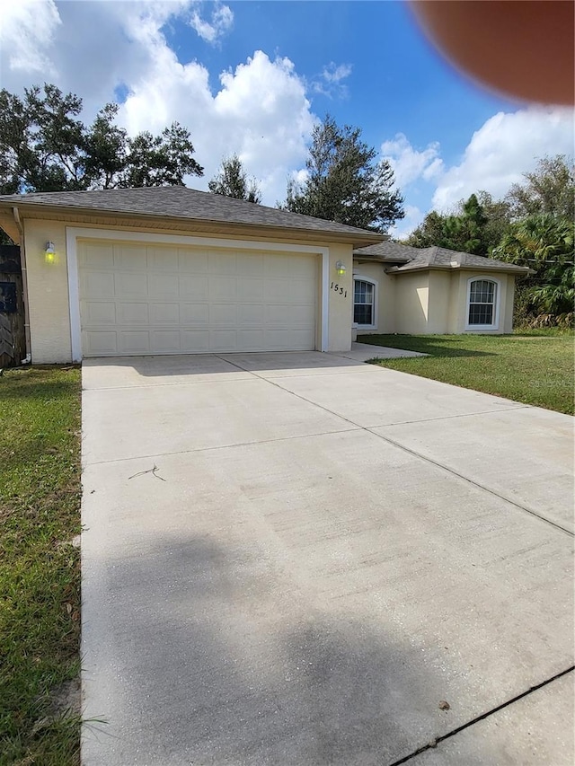 view of front facade with a garage and a front lawn