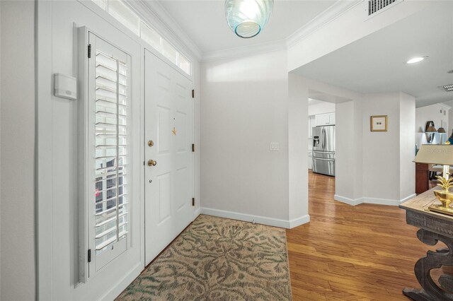 entrance foyer with crown molding and light wood-type flooring