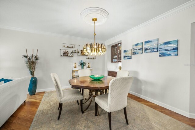 dining room featuring crown molding and hardwood / wood-style flooring