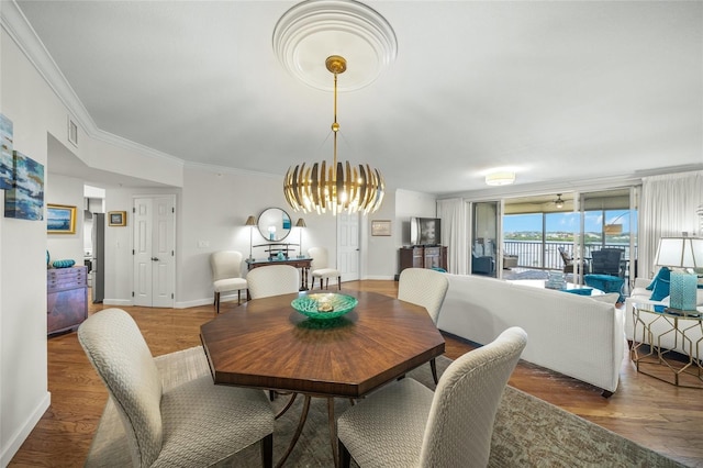 dining area with an inviting chandelier, wood-type flooring, and crown molding