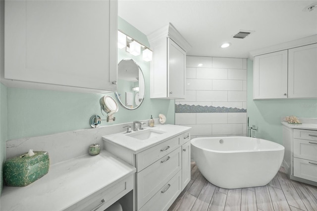 bathroom featuring vanity and a bath