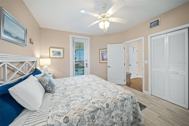 bedroom featuring access to exterior, light hardwood / wood-style flooring, a closet, and ceiling fan