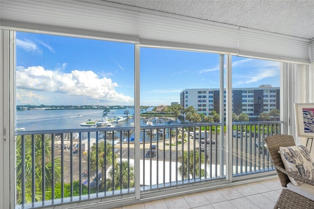 unfurnished sunroom with a water view