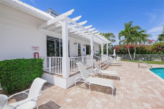 view of patio with a community pool and a pergola