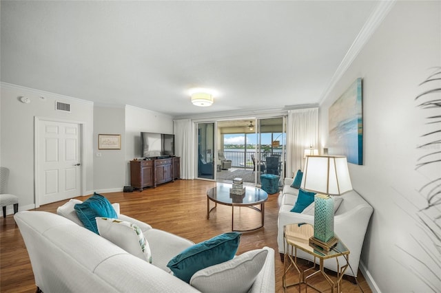 living room with crown molding and hardwood / wood-style floors