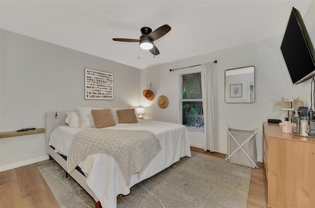 bedroom with ceiling fan and light hardwood / wood-style flooring