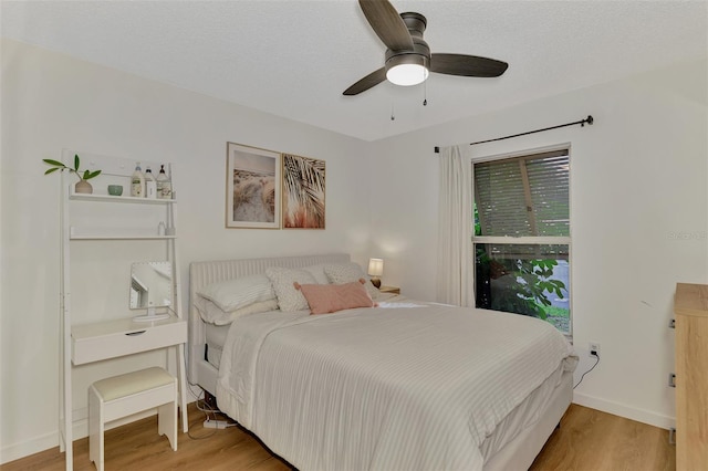 bedroom featuring a textured ceiling, hardwood / wood-style floors, and ceiling fan