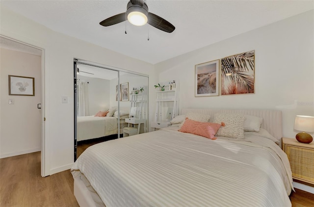 bedroom featuring ceiling fan, a closet, and light wood-type flooring