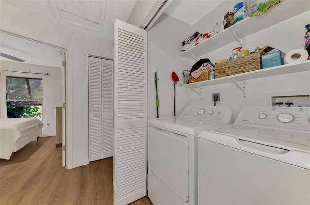 laundry room featuring separate washer and dryer and hardwood / wood-style floors