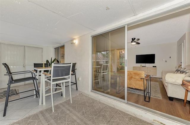 dining space featuring a textured ceiling, ceiling fan, and hardwood / wood-style flooring