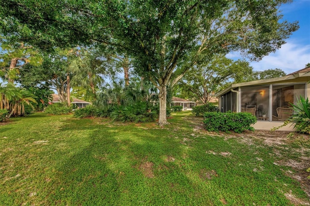 view of yard featuring a sunroom