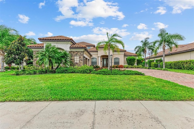 mediterranean / spanish-style house featuring a front lawn