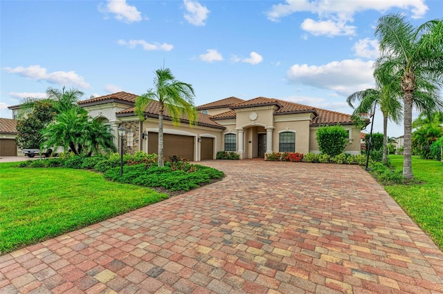 mediterranean / spanish-style house with a front yard and a garage