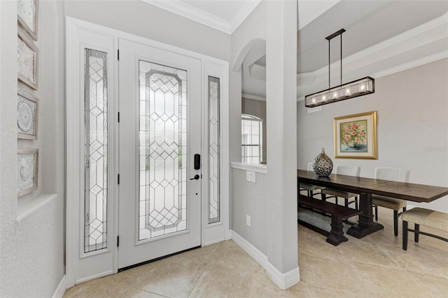 foyer entrance with light tile patterned flooring and ornamental molding