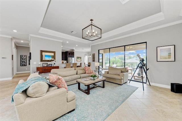 living room featuring ornamental molding, a chandelier, a raised ceiling, and light tile patterned floors