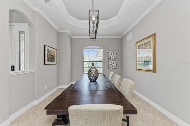 dining area featuring a raised ceiling and crown molding