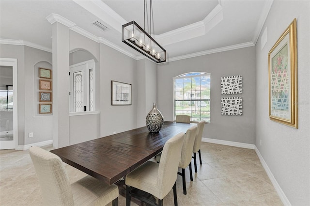 tiled dining room with a chandelier and ornamental molding