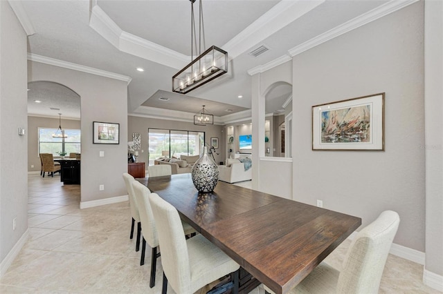 tiled dining area featuring crown molding, a chandelier, and a healthy amount of sunlight