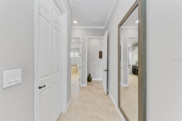 corridor featuring crown molding and light tile patterned flooring