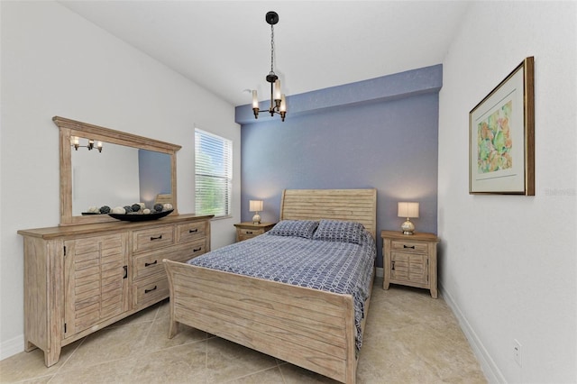 bedroom with an inviting chandelier and light tile patterned floors