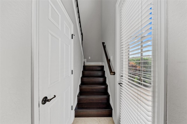 stairs featuring tile patterned floors