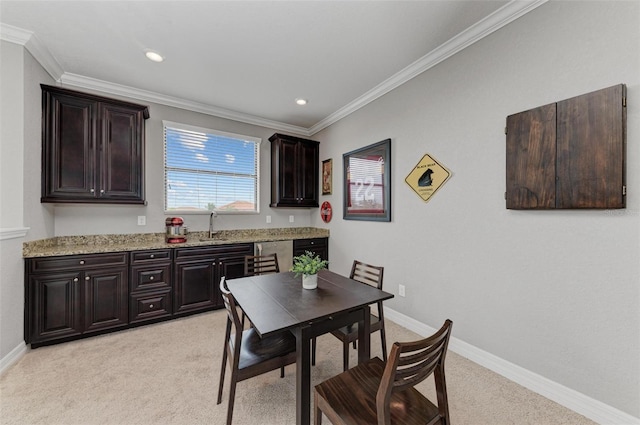 carpeted dining area featuring sink and ornamental molding