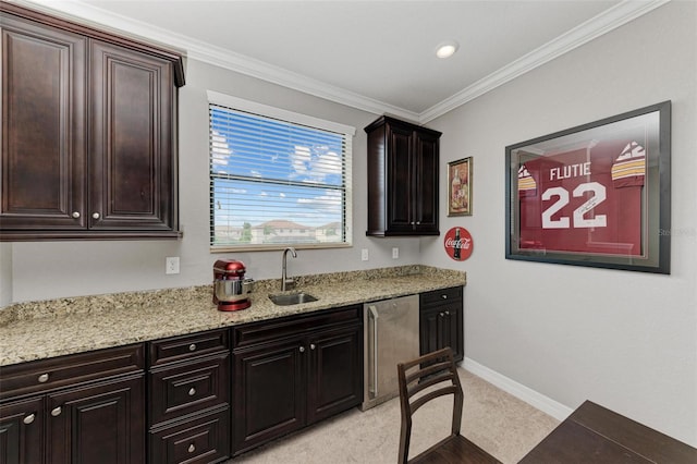 kitchen with sink, dark brown cabinetry, ornamental molding, light stone countertops, and stainless steel dishwasher