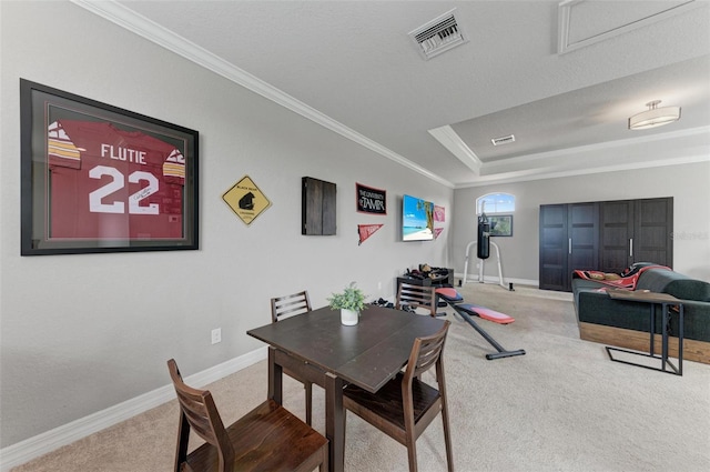 dining space with a textured ceiling, carpet flooring, and ornamental molding