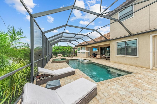 view of swimming pool with an in ground hot tub, a patio, and glass enclosure