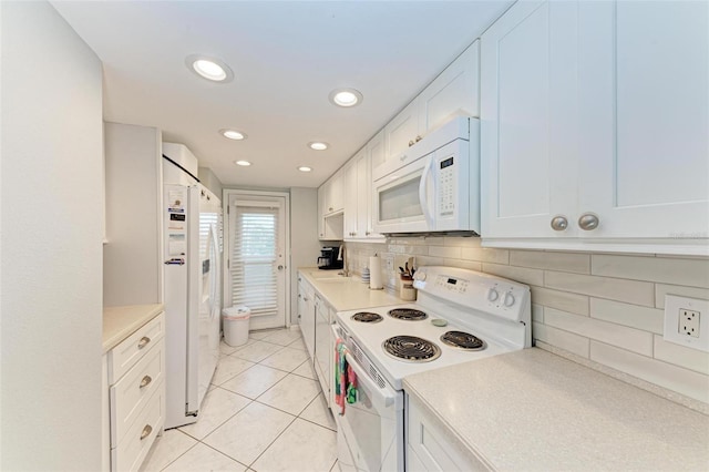 kitchen featuring white cabinets, light tile patterned floors, backsplash, and white appliances